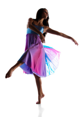 Female lyrical dancer performs a releve in attitude during a solo dance performance