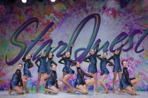 Competitive Team Performing jazz dance at starquest competition in black and blue costume