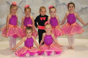 Mid American Studio girls and boys pre-ballet and rhythm preschool dance students wearing purple and pink tutu and black outfit with pink bow tie.