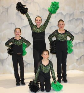 Mid American Studio Pom Students with green and black dance class costume and pompons
